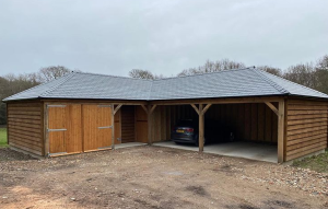 A photo of a timber garage with a car inside with a recycled plastic slate roof