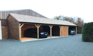 A photo of a timber carport with 2 cars parked in it