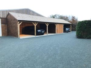 A photo of 2 cars parked in a large 5 bay carport